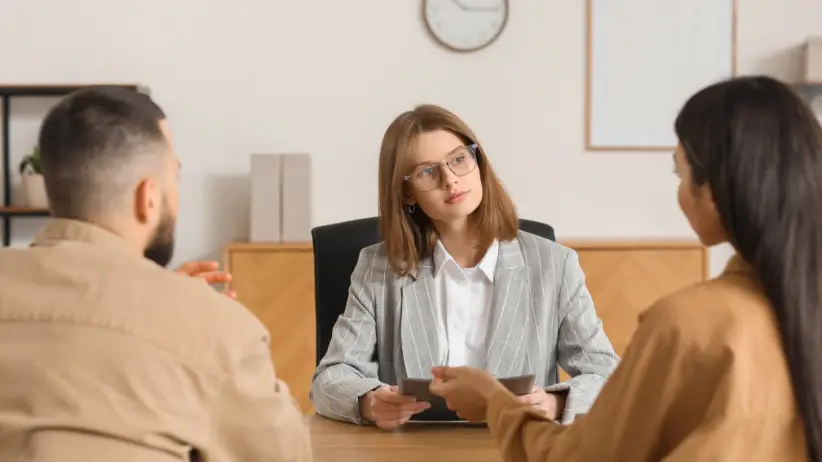 Family attorney discussing legal options with clients in a NYC office